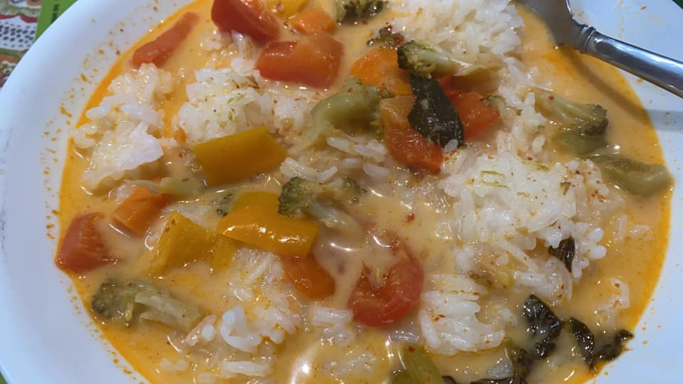 A bowl of vegetable curry with sticky rice